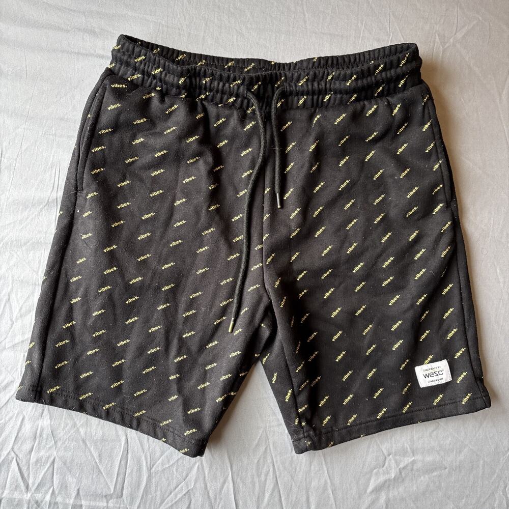 WeSC black fleece shorts featuring yellow "vibes" all over print Woman’s XL